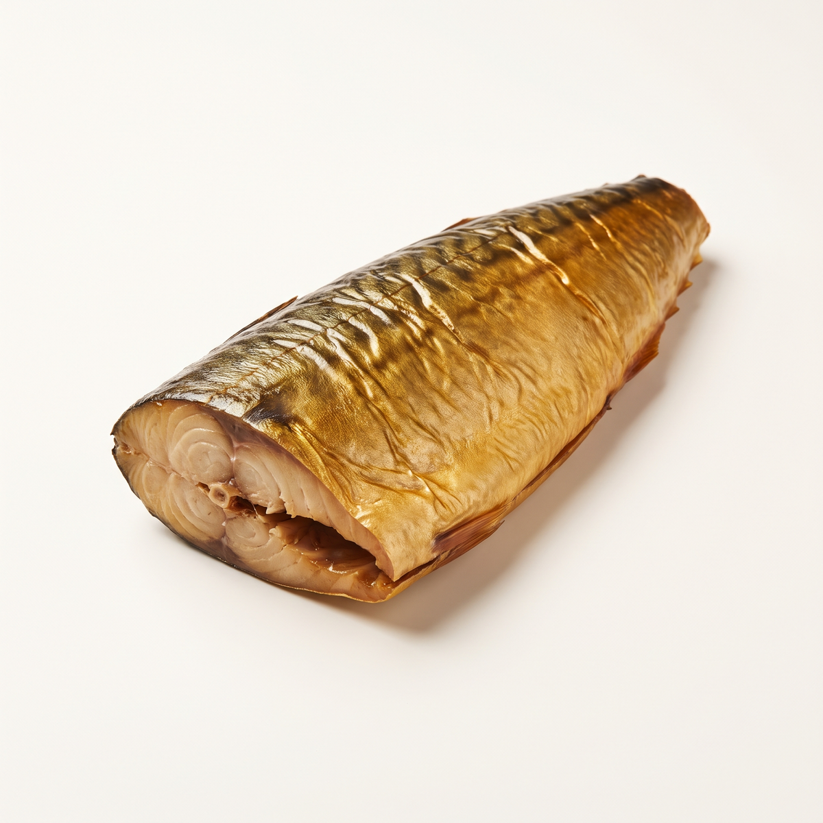 one hot-smoked mackerel fillet with golden-bronze smoked skin and a cut end revealing opaque beige flaky flesh