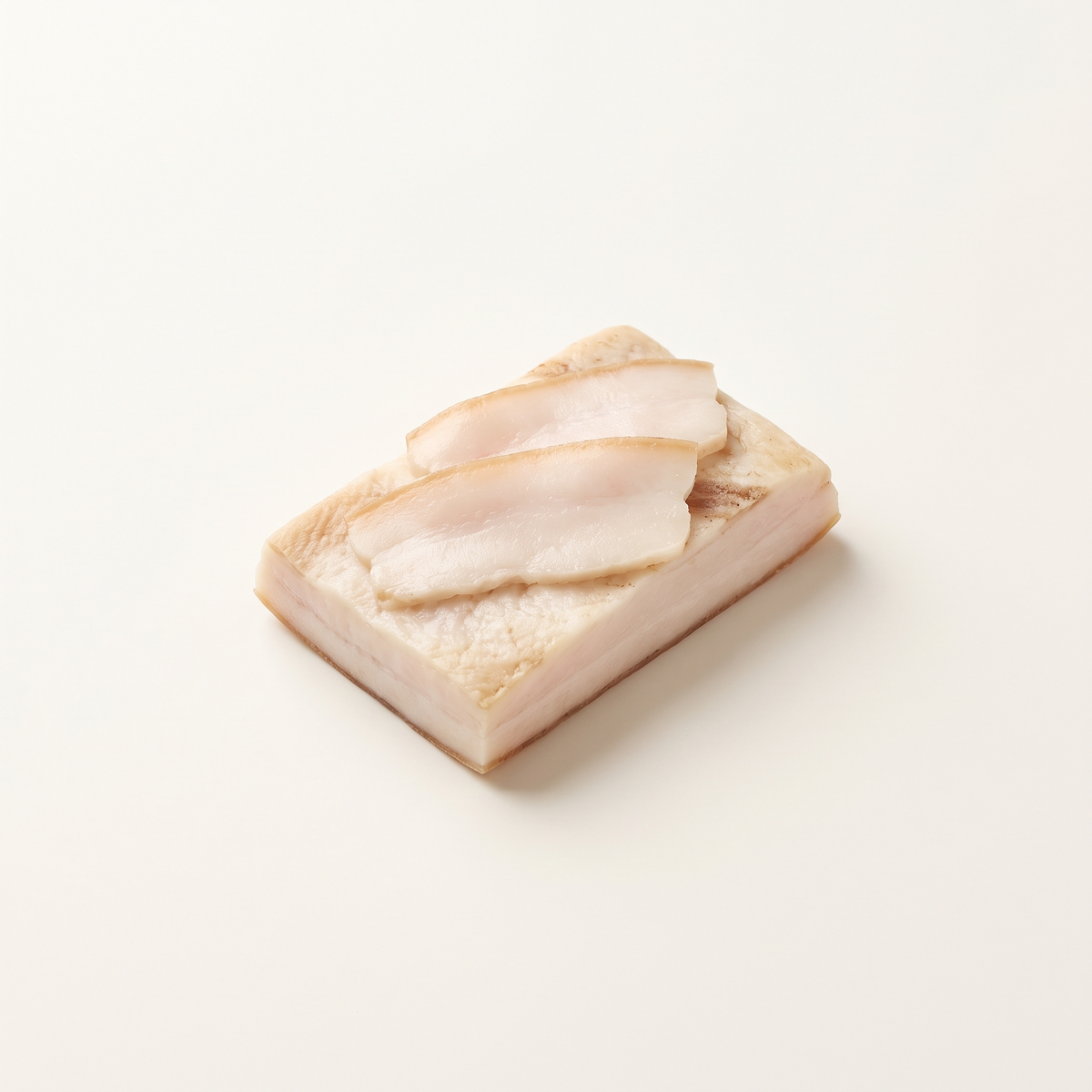 a small rectangular slab of cured pork fatback salo with three thin slices, creamy white fat and a thin pale beige rind, no bacon-like heavy meat stripes